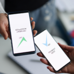 Two people completing a payment on their phones